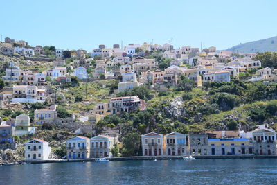 Houses in town against clear sky