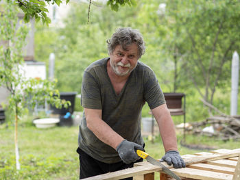 Portrait of smiling young man in yard