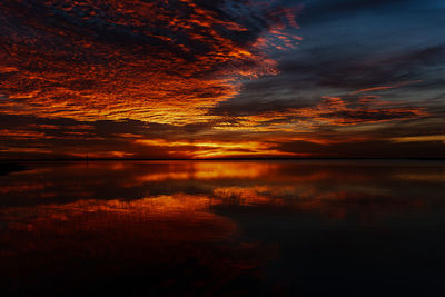 Scenic view of lake against romantic sky at sunset