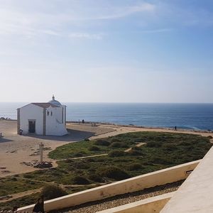 Scenic view of sea and buildings against sky