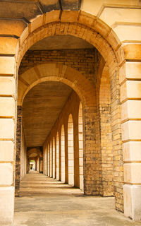 Infinite arches in a covered walkway at a london cemetery.