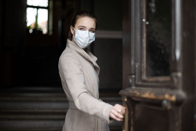 Portrait of woman standing at home