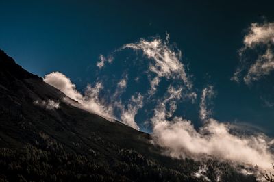 Low angle view of majestic mountains against sky