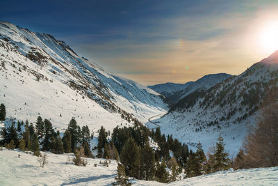 Scenic view of snow covered mountains against sky