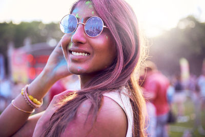 Portrait of beautiful woman wearing sunglasses at carnival