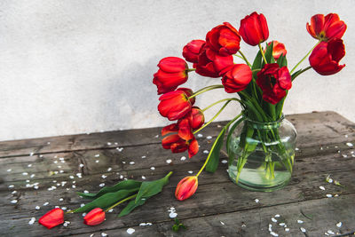 Close-up of red tulips in glass vase on table