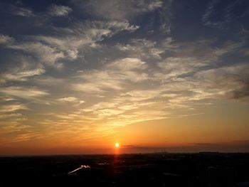 Silhouette cityscape against sky during sunset