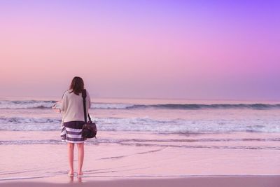 Silhouette of people standing on beach