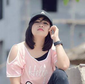 Portrait of young woman wearing hat