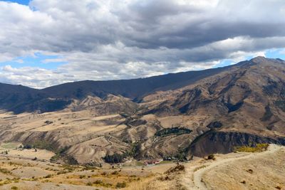 Scenic view of mountains against cloudy sky