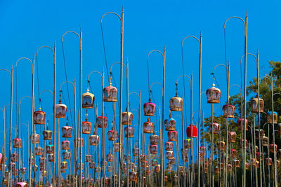 Panoramic view of metal fence against blue sky