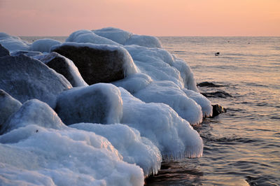 Scenic view of calm sea at sunset