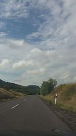 Empty road against cloudy sky