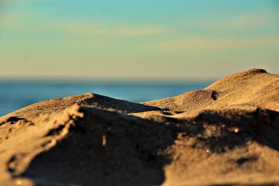 Surface level of sand on beach against sky