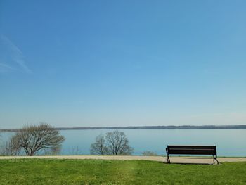 Scenic view of field against clear blue sky