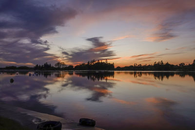 Scenic view of lake against sky during sunset