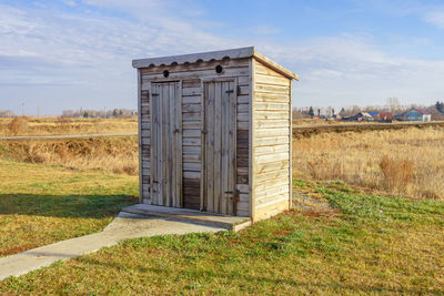 Built structure on field against sky