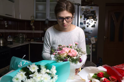 Portrait of young woman holding bouquet