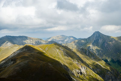 Scenic view of mountain range against cloudy sky in montemonaco, marche italy 