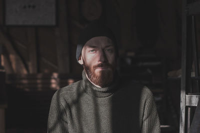 Portrait of young man standing at home