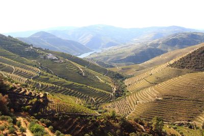 High angle view of field and mountains against sky