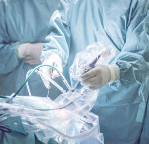 Midsection of surgeon operating patient at hospital