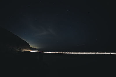 Scenic view of lake against sky at night