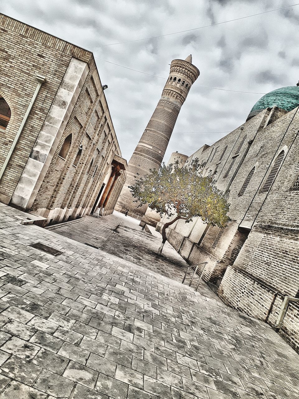 architecture, built structure, building exterior, wall, history, the past, cloud, sky, ruins, city, ancient history, nature, no people, travel destinations, rock, building, day, landmark, outdoors, monument, tower, street, travel, tourism, low angle view