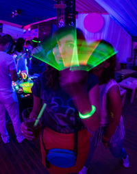 People in amusement park ride at night