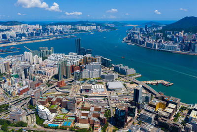 High angle view of city by sea against sky