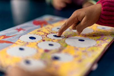 Midsection of woman with dices on table