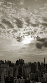 Buildings against cloudy sky