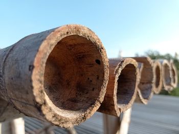 Close-up of rusty metallic structure against sky