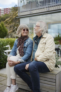 Smiling senior couple sitting outdoors