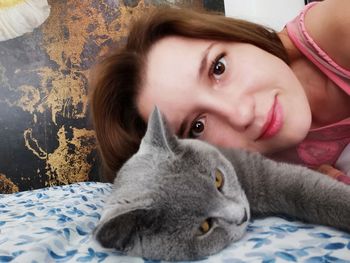 Portrait of young woman lying down on bed