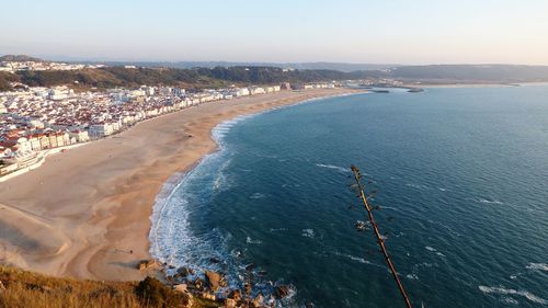 High angle view of sea and cityscape against sky