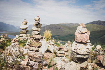 Stack of rocks on mountain against sky