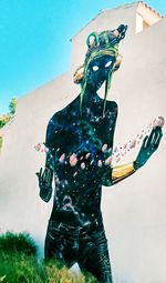 Rear view of woman standing against sky