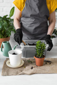 Midsection of man holding coffee on table