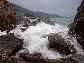 Close-up of wave splashing on rocks at shore