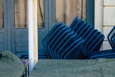 Chairs stacked by table outside restaurant