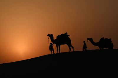 Silhouette people at sunset