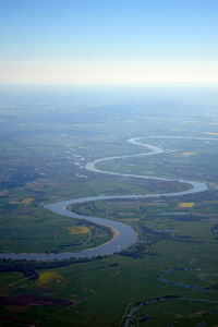 Aerial view of river amidst landscape against sky