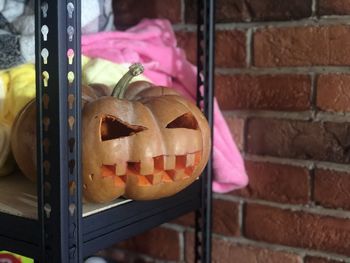 Close-up of pumpkin on brick wall