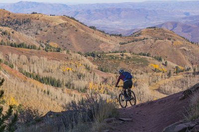 High angle view of man riding bicycle on mountain