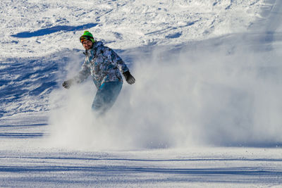 Man skiing on snow covered landscape