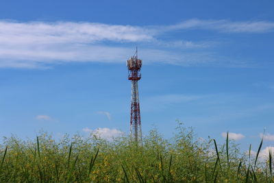 Low angle view of communications tower against sky