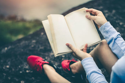 High angle view of hand holding book