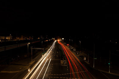 High angle view of light trails on highway at night