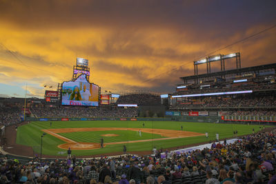 People at town square against sky during sunset